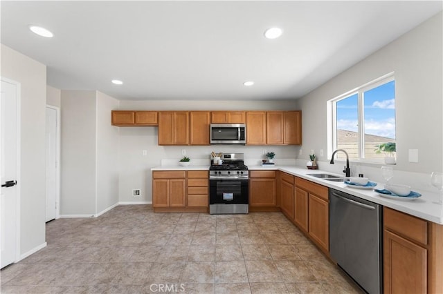 42570 72nd St W, Lancaster, CA 93536 - kitchen featuring light countertops, brown cabinets, appliances with stainless steel finishes, and a sink