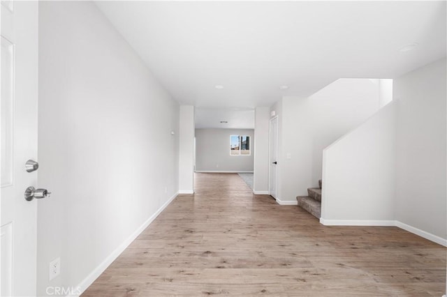 42570 72nd St W, Lancaster, CA 93536 - hall with recessed lighting, baseboards, wood finished floors, and stairway