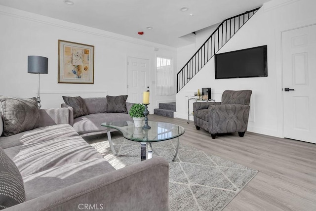 living area featuring crown molding, stairs, wood finished floors, baseboards, and recessed lighting