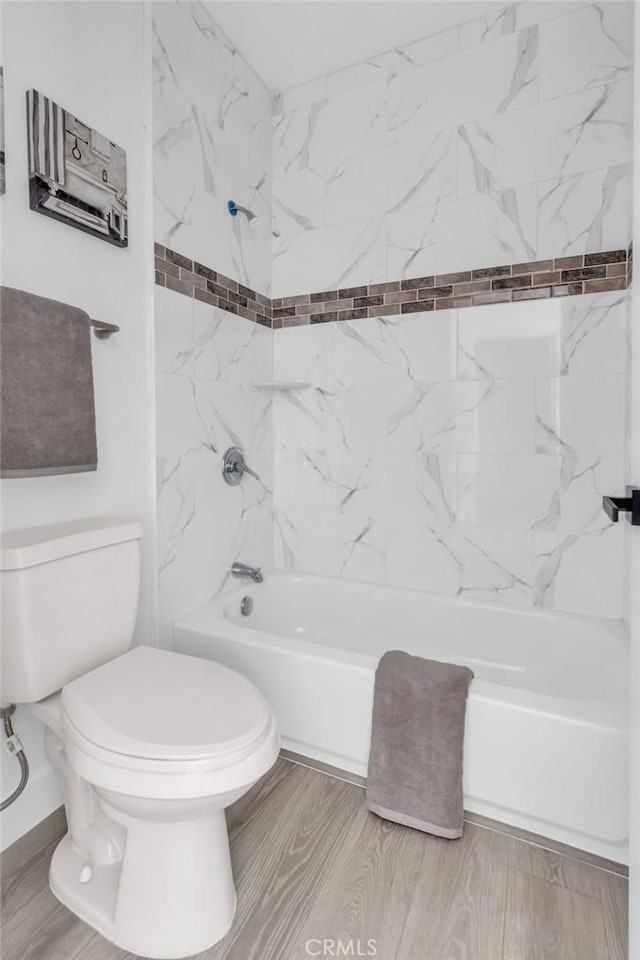 bathroom with toilet and shower / washtub combination