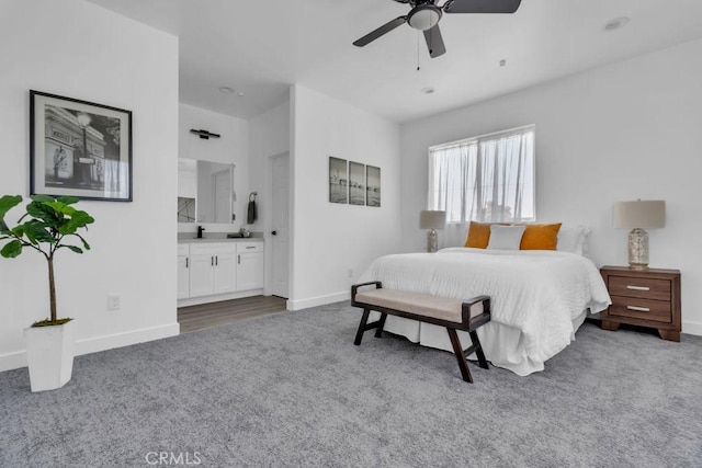 bedroom with baseboards, carpet, and ensuite bathroom