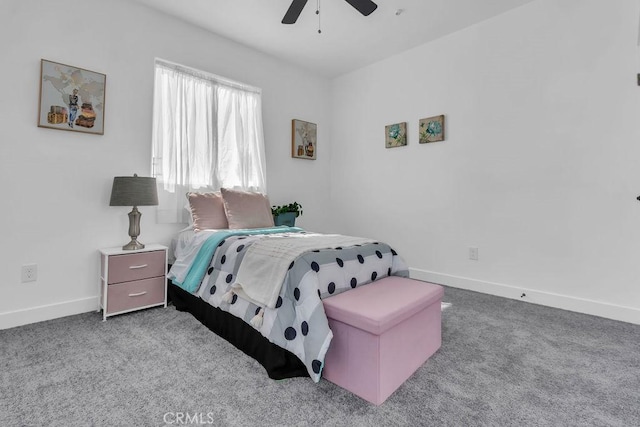 carpeted bedroom featuring baseboards and ceiling fan
