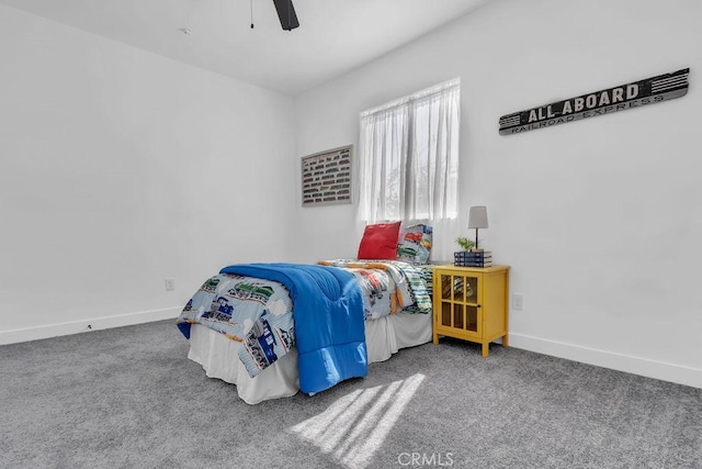 carpeted bedroom featuring baseboards and a ceiling fan