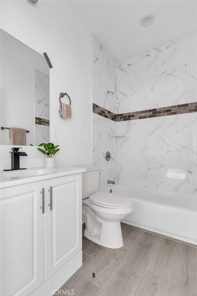 full bathroom with vanity, shower / bath combination, toilet, and wood finished floors