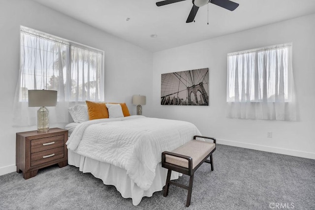 carpeted bedroom with a ceiling fan and baseboards