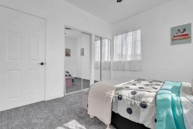 carpeted bedroom with multiple closets