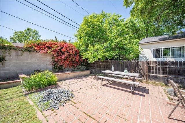view of patio featuring a fenced backyard and outdoor dining space
