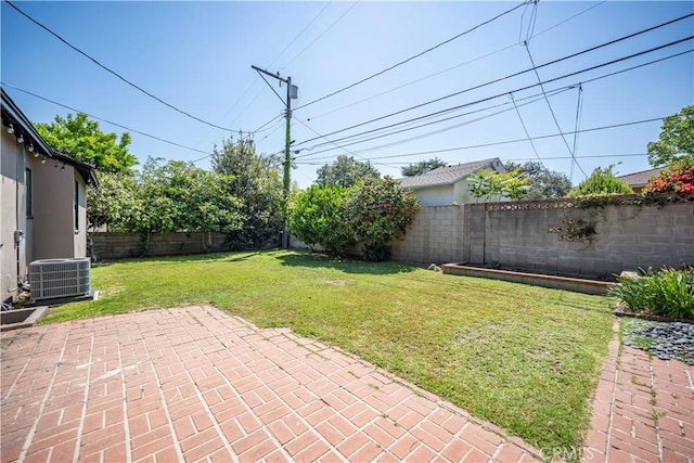 view of yard with central air condition unit, a patio, and a fenced backyard