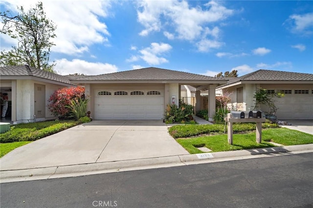 single story home with an attached garage, stucco siding, and concrete driveway
