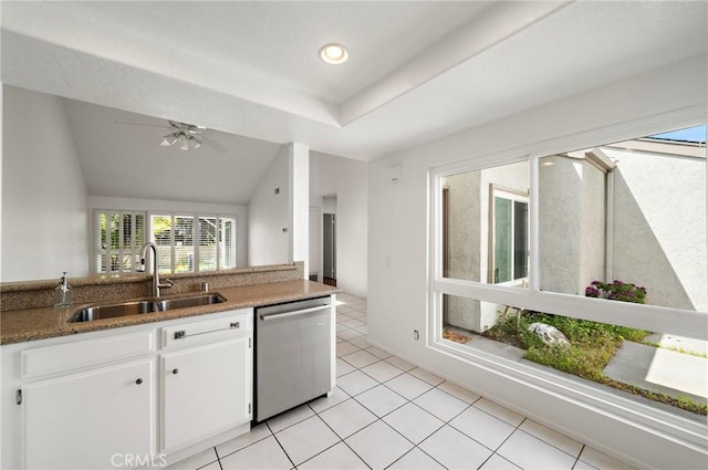 kitchen with light tile patterned flooring, ceiling fan, a sink, white cabinetry, and stainless steel dishwasher