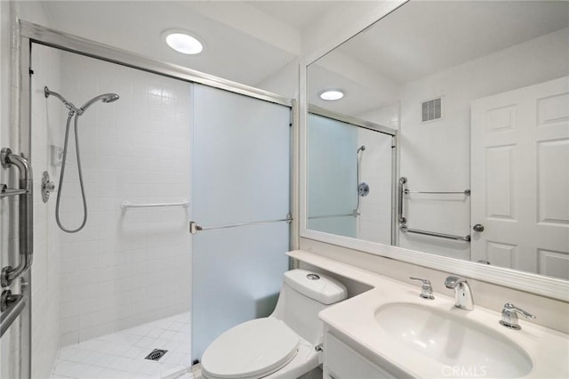bathroom featuring vanity, a stall shower, toilet, and visible vents