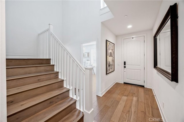 1253 Viejo Hills Dr, Lake Forest, CA 92610 - foyer entrance featuring light wood finished floors, stairs, recessed lighting, baseboards, and a high ceiling