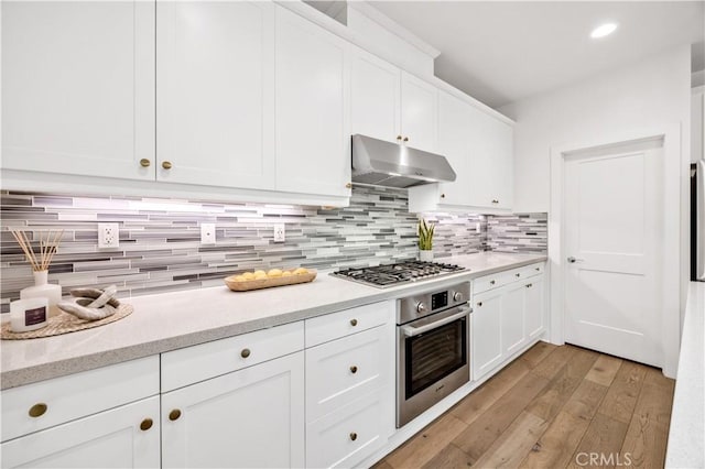 1253 Viejo Hills Dr, Lake Forest, CA 92610 - kitchen with stainless steel appliances, under cabinet range hood, light wood-type flooring, decorative backsplash, and recessed lighting