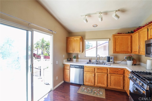 3667 Sonoma Oaks Ave, Perris, CA 92571 - kitchen featuring tile countertops, appliances with stainless steel finishes, brown cabinets, a sink, and dark wood-type flooring