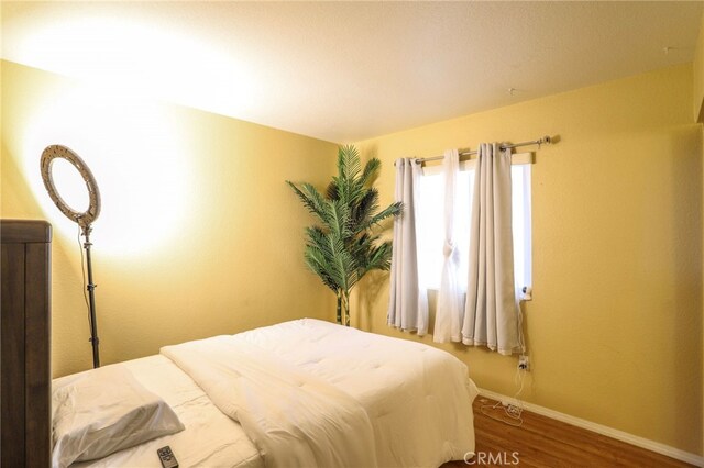 3667 Sonoma Oaks Ave, Perris, CA 92571 - bedroom with baseboards and wood finished floors