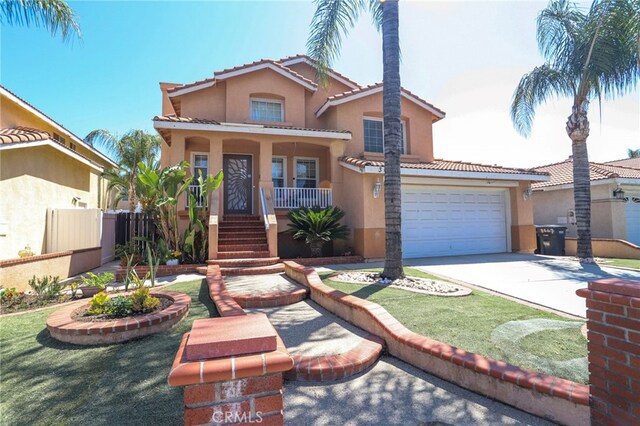3667 Sonoma Oaks Ave, Perris, CA 92571 - mediterranean / spanish home featuring covered porch, a tiled roof, driveway, fence, and stucco siding