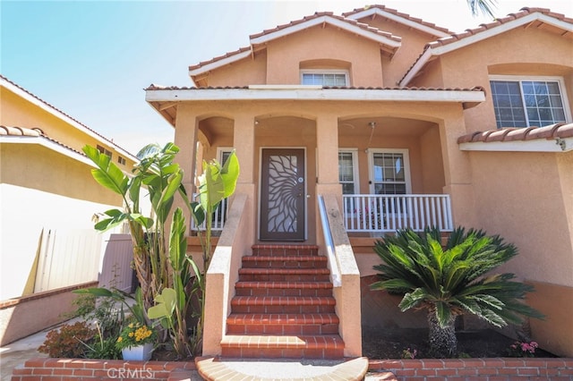 3667 Sonoma Oaks Ave, Perris, CA 92571 - doorway to property with stucco siding, a tiled roof, and covered porch