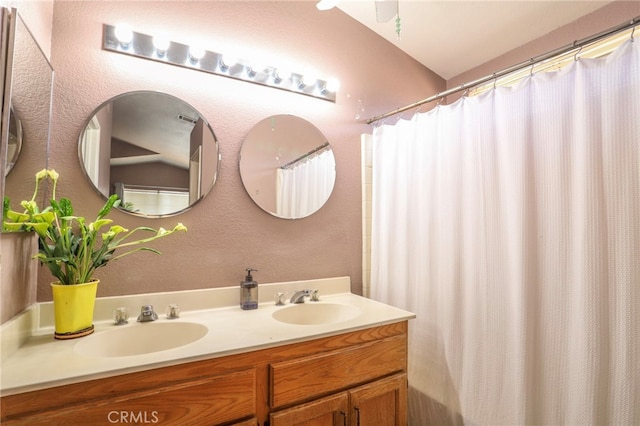 3667 Sonoma Oaks Ave, Perris, CA 92571 - bathroom with a sink, a textured wall, and double vanity