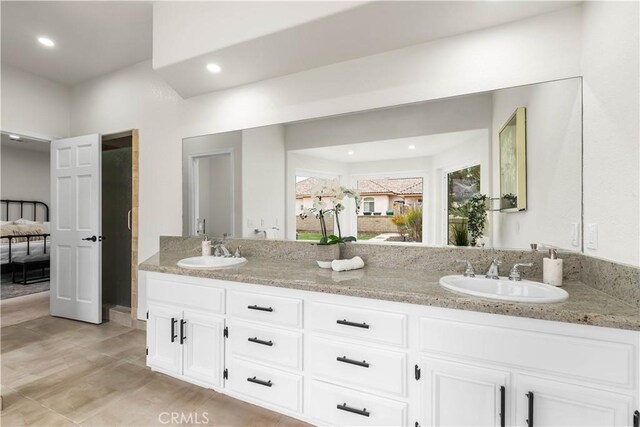 bathroom featuring a sink, recessed lighting, and double vanity