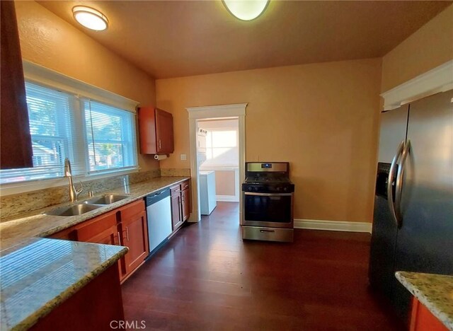 530 S Broadway, Santa Ana, CA 92701 - kitchen featuring appliances with stainless steel finishes, a sink, light stone counters, brown cabinetry, and dark wood-style floors