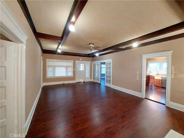 530 S Broadway, Santa Ana, CA 92701 - unfurnished living room with ceiling fan, a textured ceiling, dark wood-style floors, beam ceiling, and baseboards