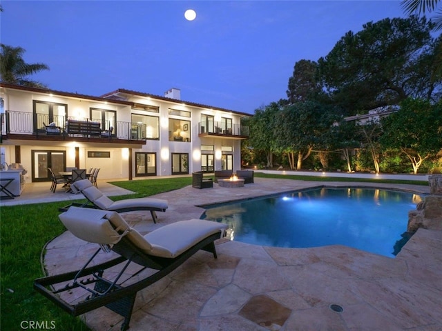 outdoor pool with french doors and a patio area