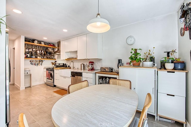 30735 Calle Resplendor, San Juan Capistrano, CA 92675 - kitchen featuring light countertops, stainless steel appliances, white cabinetry, and wall chimney exhaust hood