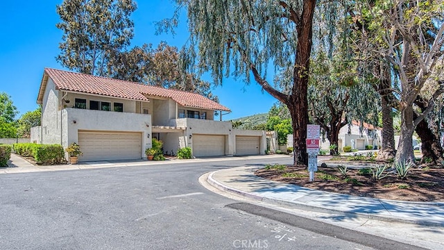 30735 Calle Resplendor, San Juan Capistrano, CA 92675 - view of front of house featuring a garage, a tiled roof, and stucco siding