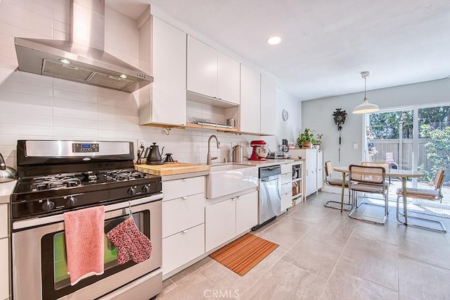 30735 Calle Resplendor, San Juan Capistrano, CA 92675 - kitchen featuring a sink, light countertops, stainless steel appliances, and wall chimney exhaust hood