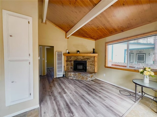 living room with baseboards, lofted ceiling with beams, wood finished floors, and wooden ceiling