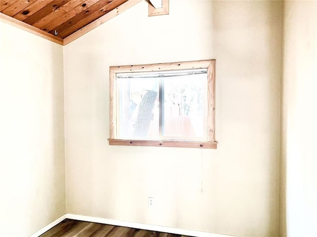 spare room featuring wood ceiling, baseboards, dark wood-style flooring, and lofted ceiling
