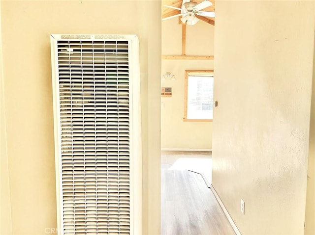 details with a ceiling fan, a heating unit, and baseboards