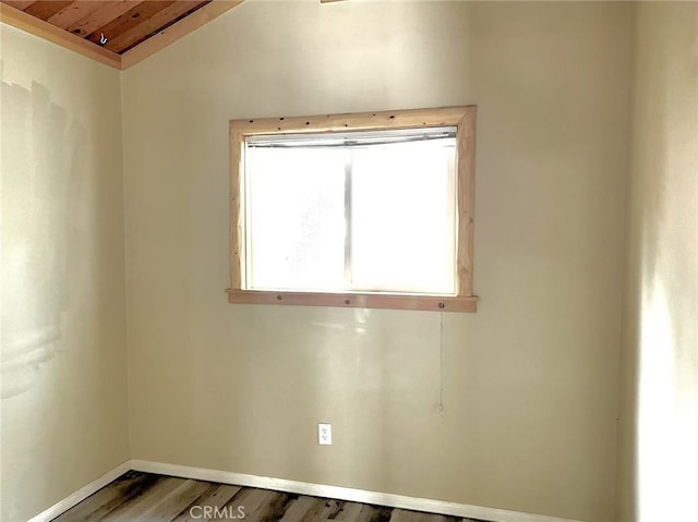 spare room featuring baseboards, wooden ceiling, wood finished floors, and lofted ceiling