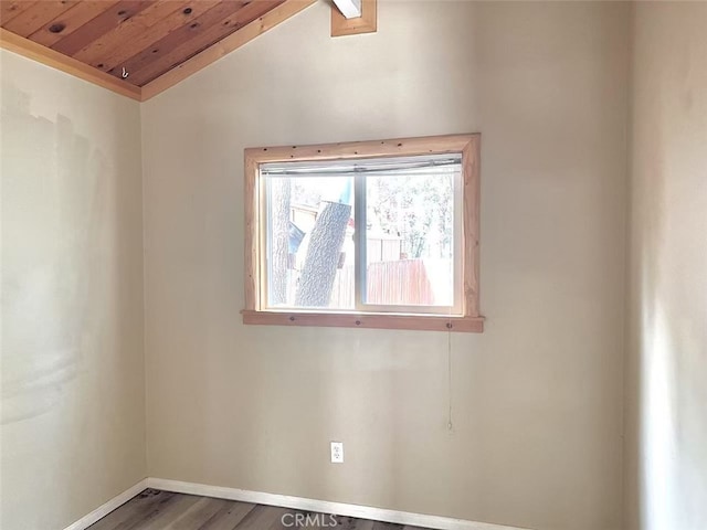 empty room featuring baseboards, wood ceiling, lofted ceiling, and wood finished floors