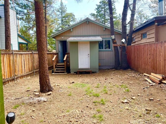 rear view of house with a fenced backyard