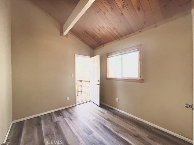 empty room with baseboards, vaulted ceiling with beams, wood ceiling, and wood finished floors