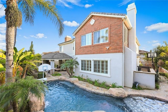 18345 Watson Way, Yorba Linda, CA 92886 - rear view of house featuring fence, a chimney, an outdoor pool, and brick siding
