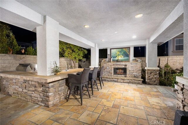 18345 Watson Way, Yorba Linda, CA 92886 - view of patio / terrace featuring outdoor wet bar, area for grilling, and an outdoor stone fireplace