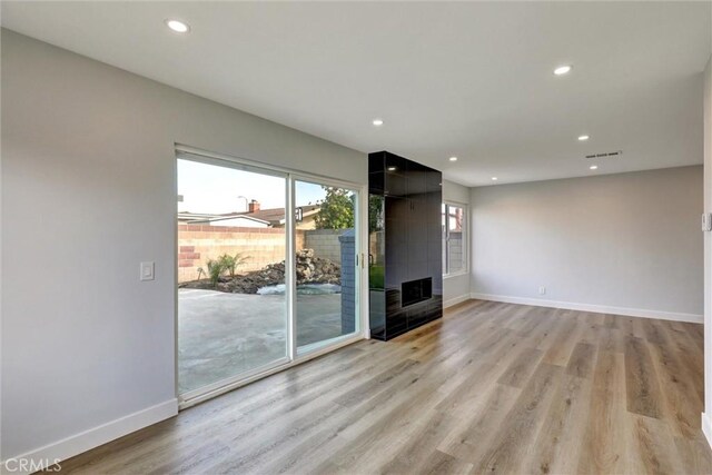 unfurnished living room featuring recessed lighting, baseboards, visible vents, and light wood finished floors