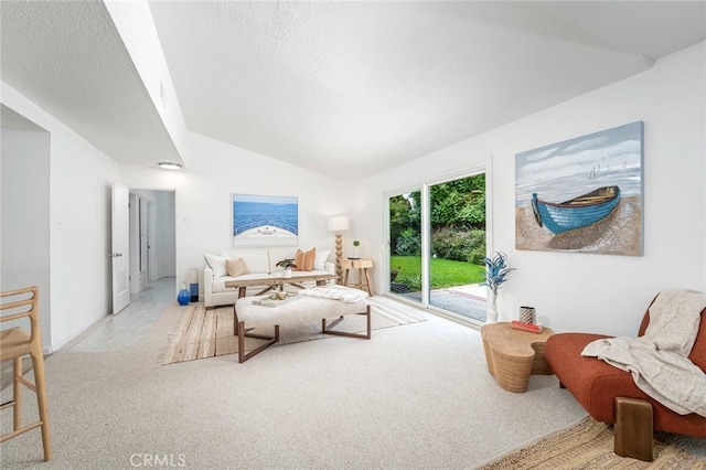 interior space with access to outside, a textured ceiling, carpet floors, and vaulted ceiling