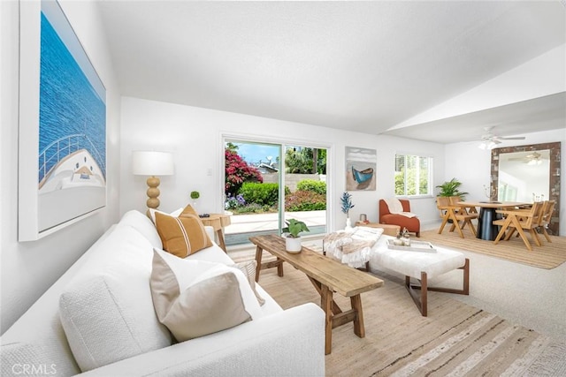 living room with carpet flooring, ceiling fan, and vaulted ceiling