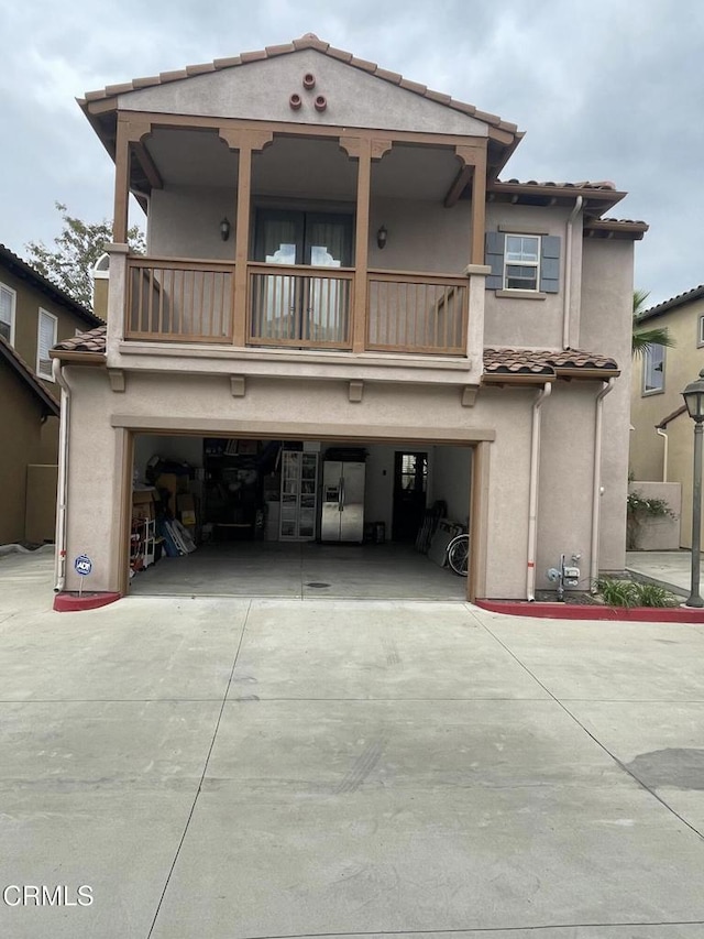 1117 Patel Pl, Duarte, CA 91010 - view of front of house featuring an attached garage, stucco siding, a balcony, and driveway