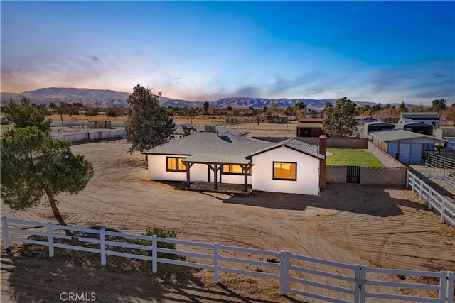 exterior space with stucco siding, a fenced backyard, and a mountain view