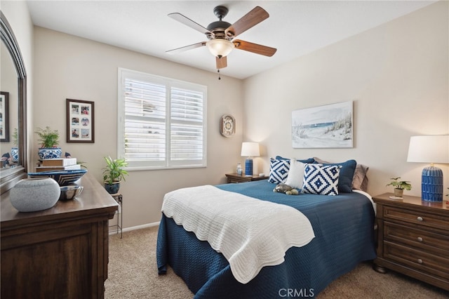 bedroom featuring a ceiling fan, baseboards, and light carpet