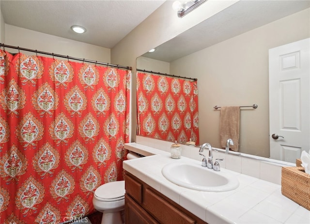 bathroom with vanity, toilet, and curtained shower