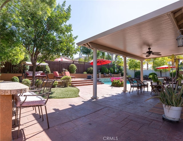 view of patio with a fenced in pool, a fenced backyard, outdoor dining area, and outdoor dry bar