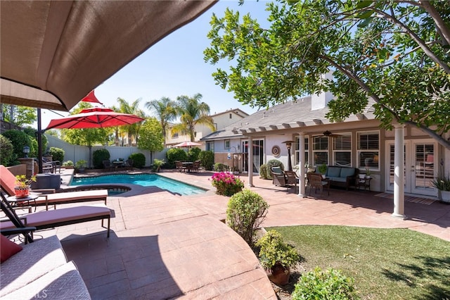 view of swimming pool with ceiling fan, a patio area, a fenced in pool, a fenced backyard, and an outdoor hangout area