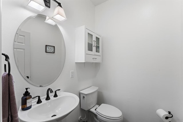half bathroom featuring a sink and toilet