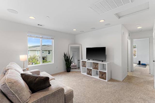 living area featuring visible vents, baseboards, attic access, light colored carpet, and recessed lighting