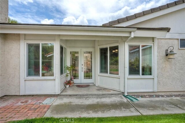 doorway to property with french doors and stucco siding